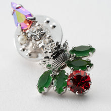 画像をギャラリービューアに読み込む, ヒイラギの上に置かれたろうそくをイメージしたビジューバッジ